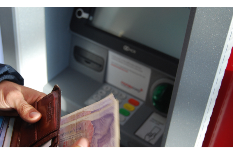 Withdrawing money from an ATM.