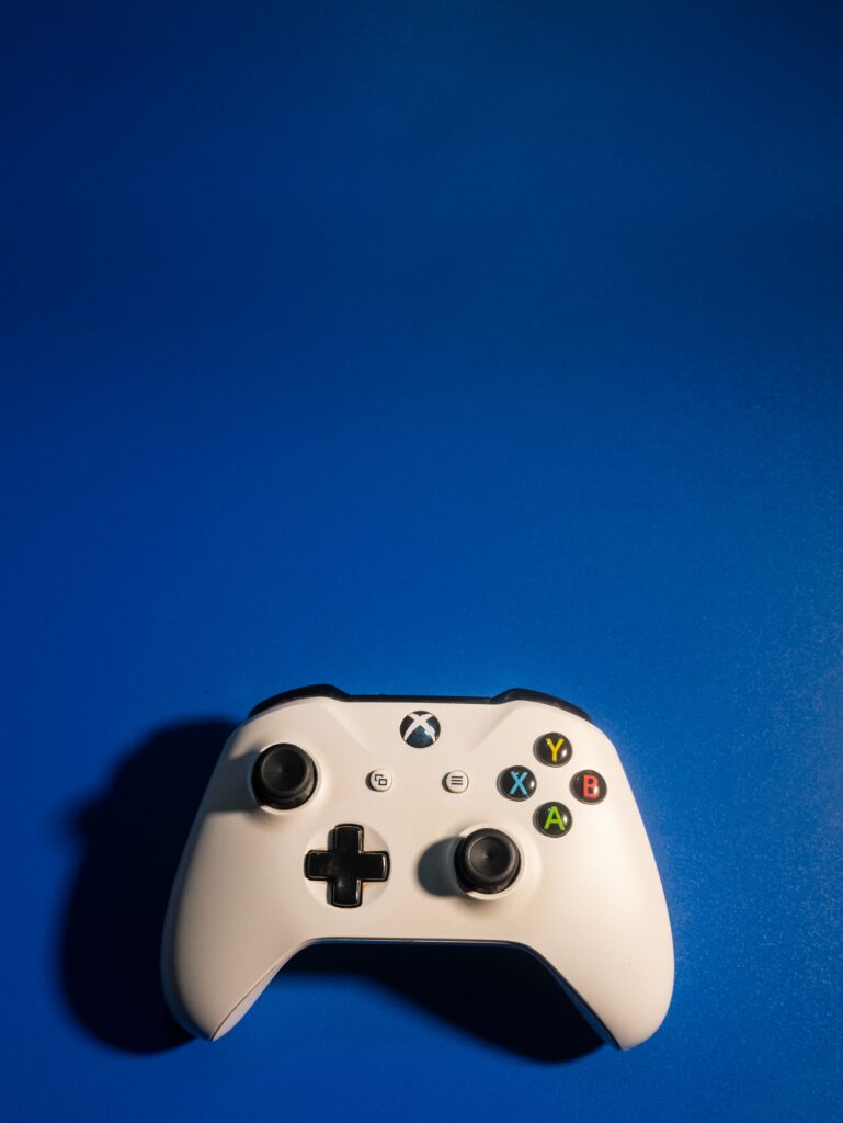 A white xBox controller in a blue background