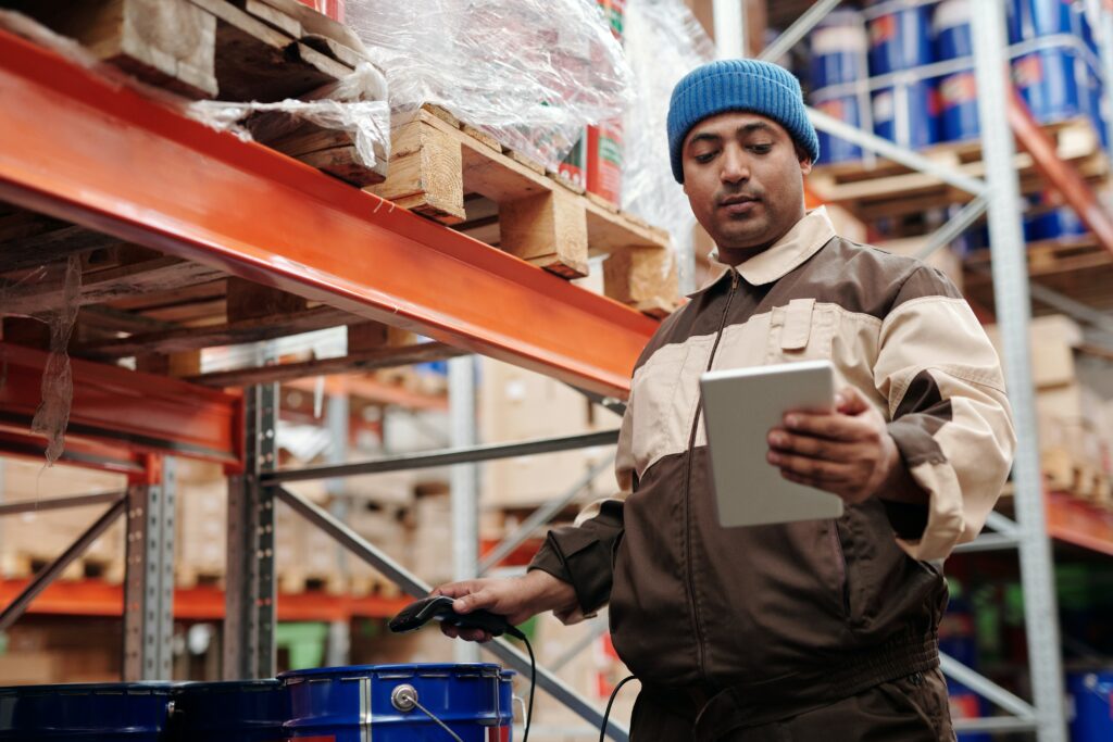 Warehouse worker scanning product barcode in warehouse