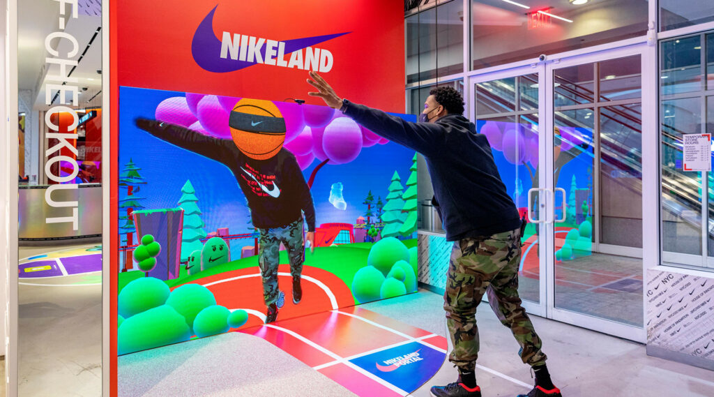 The Nikeland part of Nike's NYC store, a man who uses AR technology and sees his avatar.