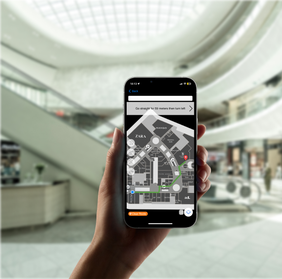 Shopper using Poilabs indoor navigation on a smartphone to find stores inside a shopping mall