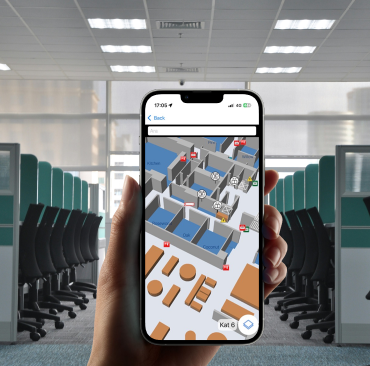 Employee using Poilabs indoor navigation on a smartphone to find rooms inside an office workplace